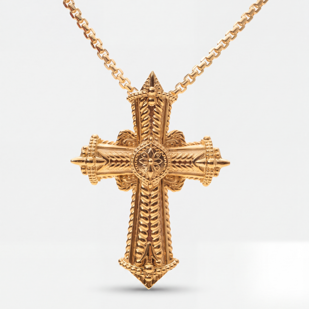 An ornate gold cross pendant necklace with intricate textured details, shown on a clean white background.
